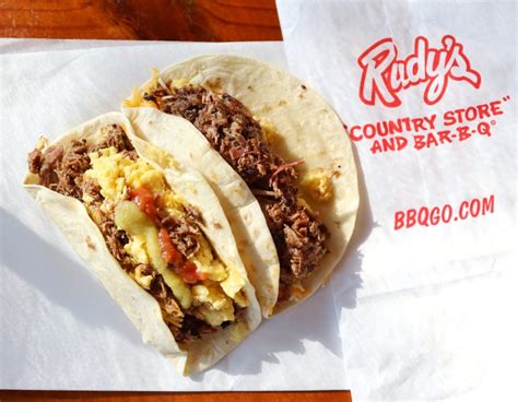 Rudy's breakfast tacos - Ingredients. 1/2 package hashed brown potatoes; 6 eggs, scrambled; 4 slices of bacon, cooked and cut into bite-sized pieces; 4 sausage links, cooked and cut into bite-sized pieces